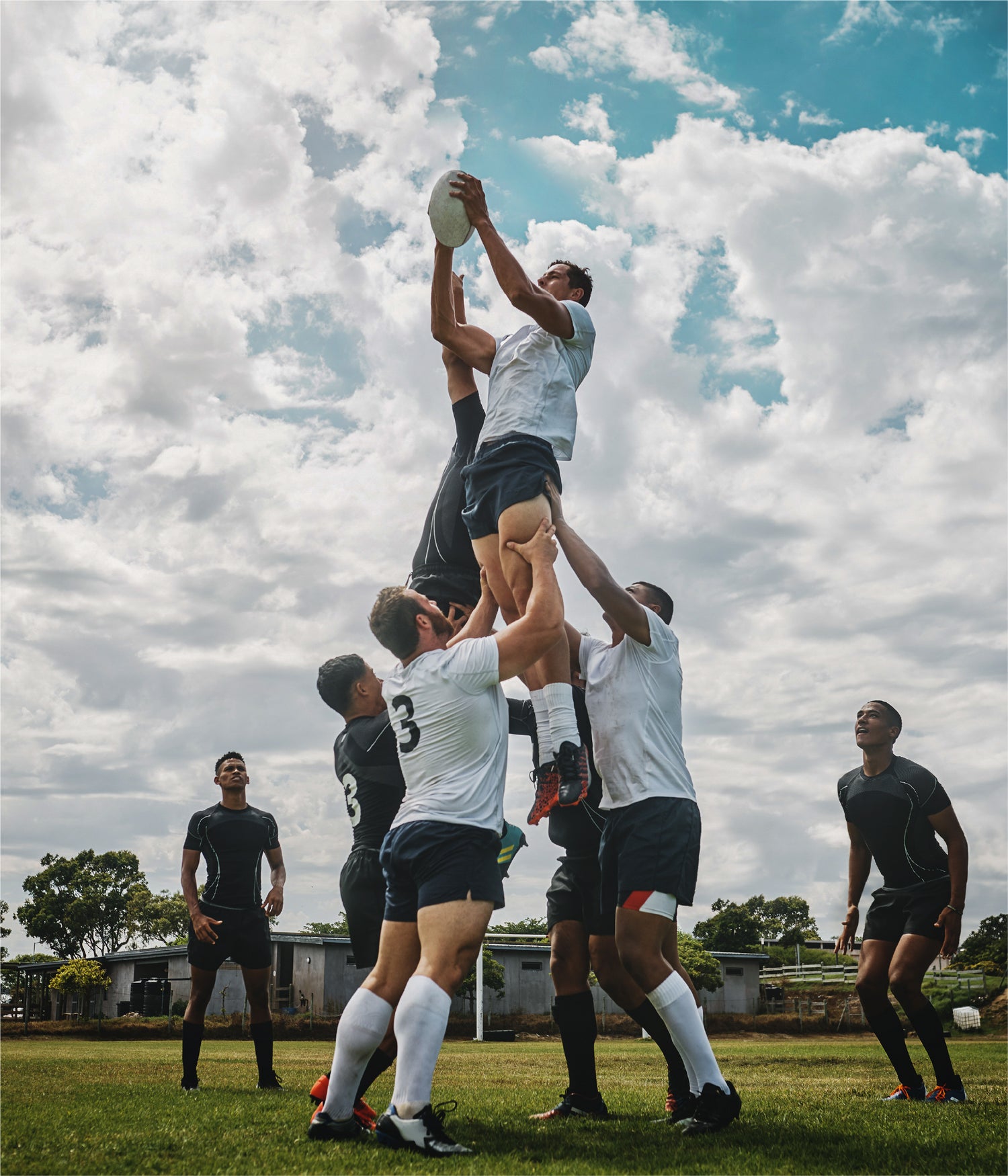 Rugby lineout lift with players catching the ball—showcasing teamwork, athleticism, and rugby-specific movement fundamentals.
