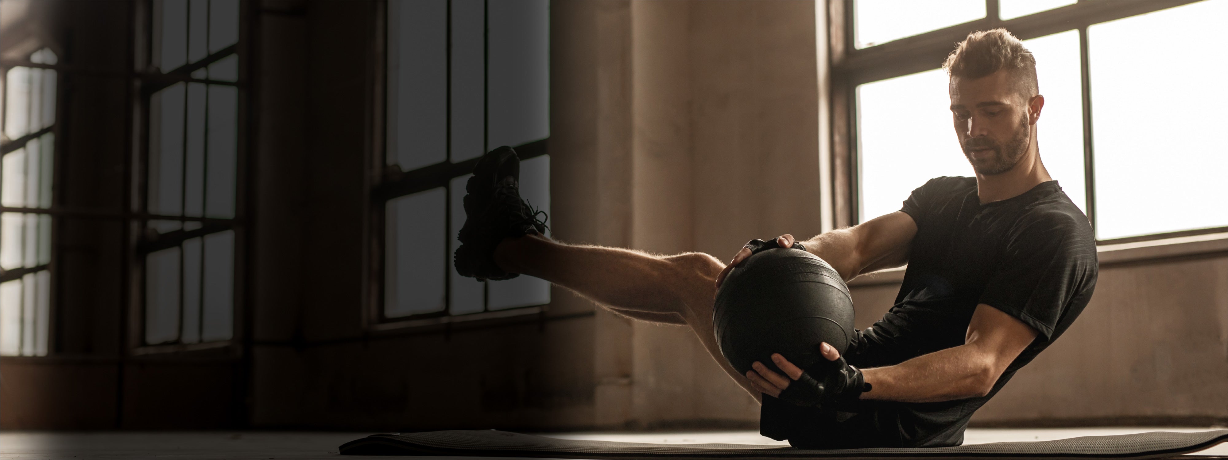 Rugby athlete training core with medicine ball during functional strength workout — symbolizing mobility, core strength, and conditioning focus in Peak Rugby training programs.